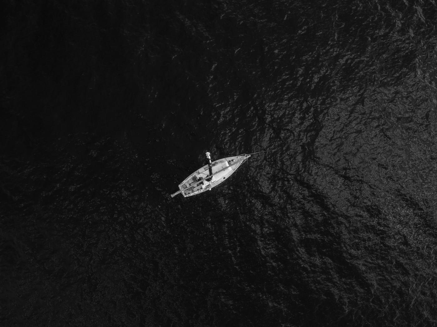Яхта на тёмной воде, вид сверху